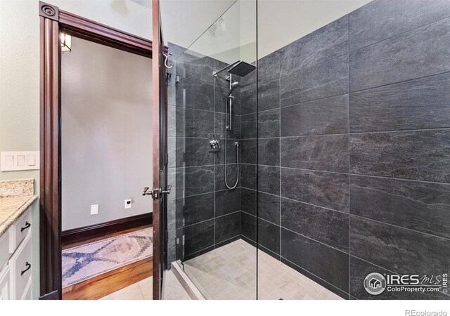 bathroom featuring a shower stall and vanity