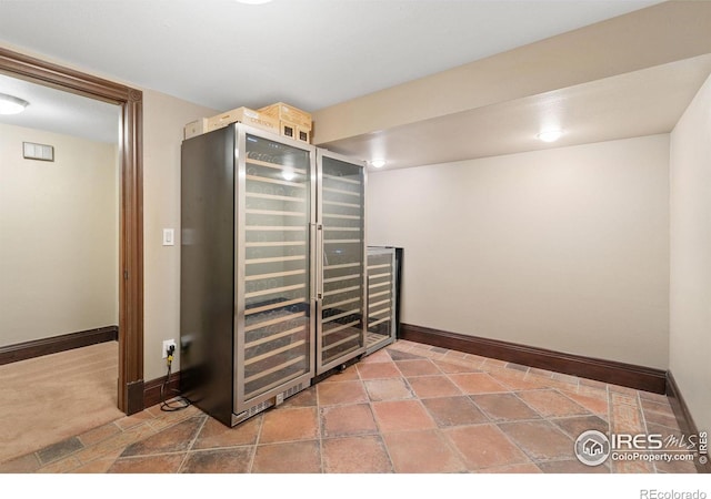 interior space featuring beverage cooler and baseboards