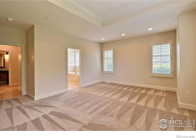 empty room featuring light colored carpet, crown molding, recessed lighting, baseboards, and a smoke detector