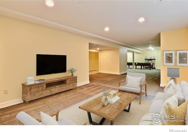 living room with baseboards and recessed lighting