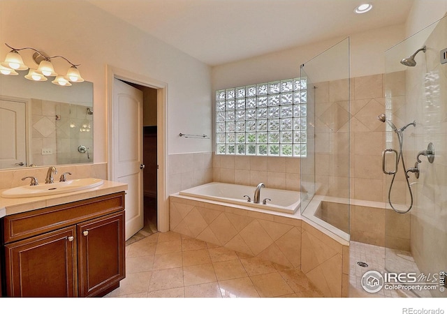 full bathroom with tile patterned flooring, tiled shower, a bath, vanity, and recessed lighting