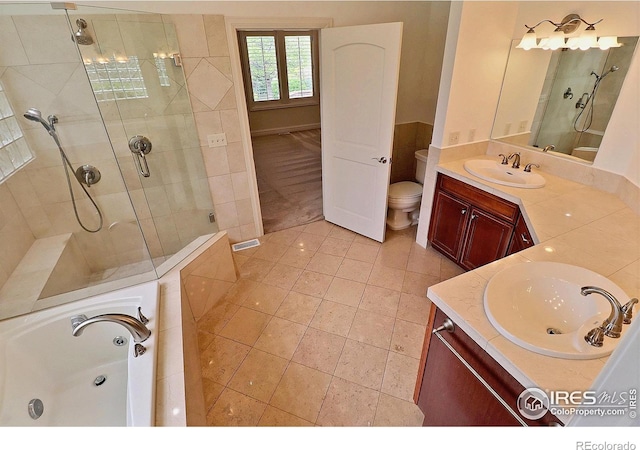 full bath featuring a shower stall, vanity, tile patterned flooring, a bath, and toilet