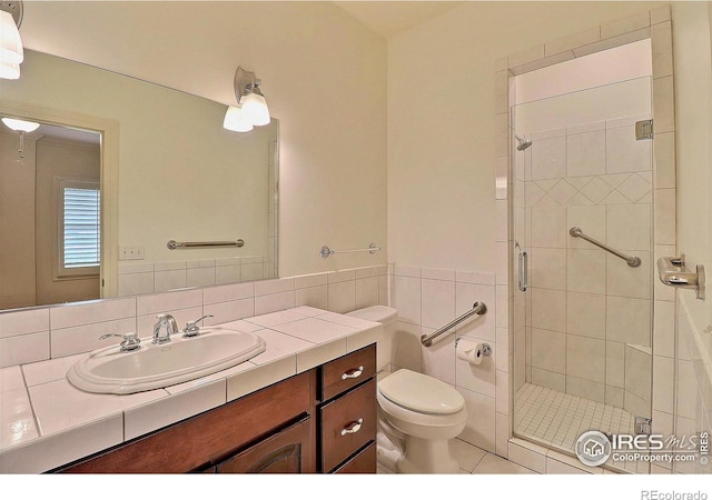 bathroom featuring a stall shower, toilet, and vanity