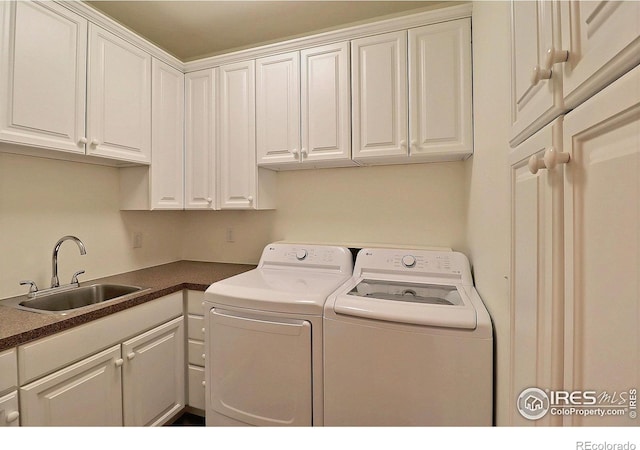 laundry room featuring independent washer and dryer and cabinet space