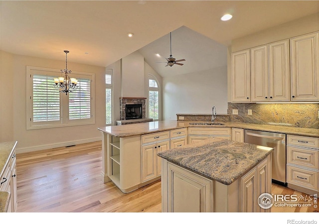 kitchen with stainless steel dishwasher, a sink, a peninsula, ceiling fan, and open shelves