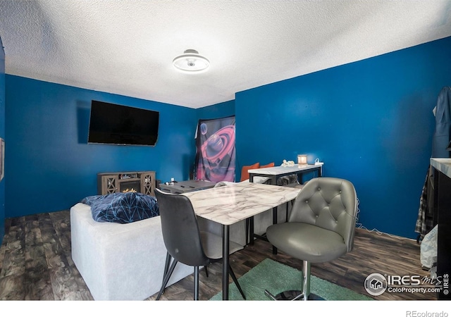 home office featuring wood finished floors and a textured ceiling