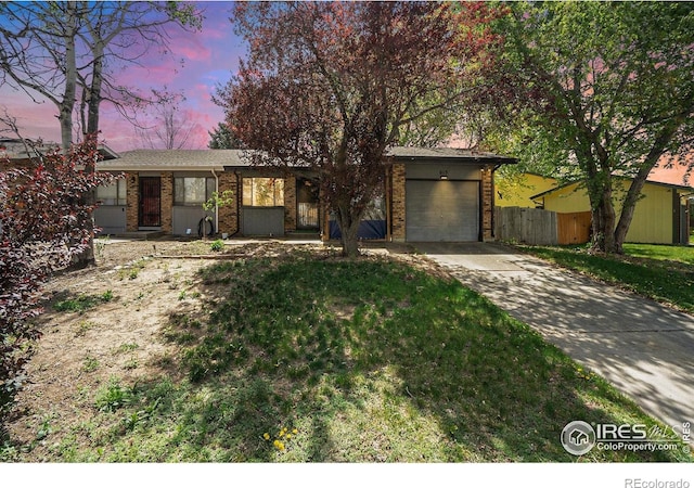 view of front of house with a garage, driveway, and brick siding