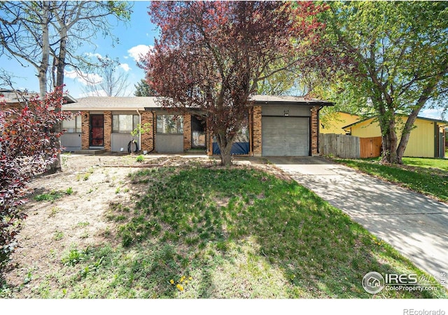 view of front of home with an attached garage, concrete driveway, and brick siding