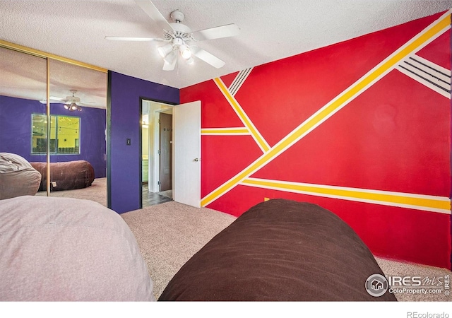 carpeted bedroom featuring a textured ceiling and ceiling fan