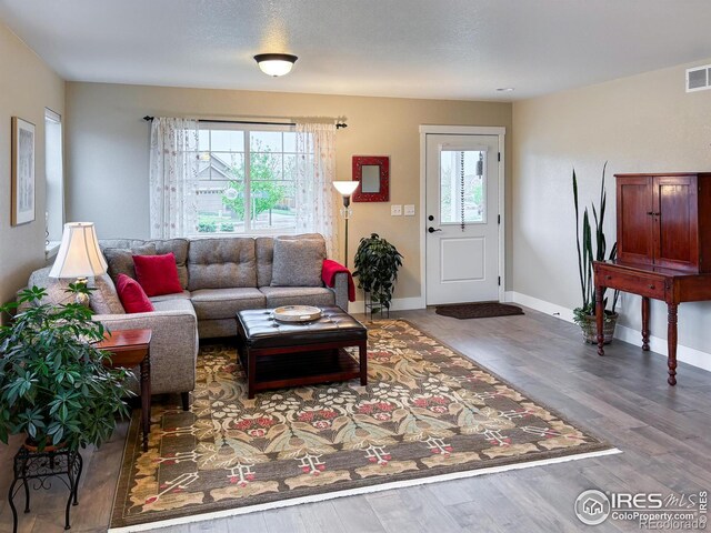 living area featuring wood finished floors and baseboards