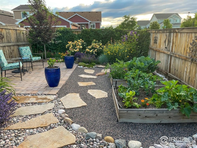 2793 Red Wheat Trl, Berthoud, CO 80513 - fenced backyard with a garden and a patio