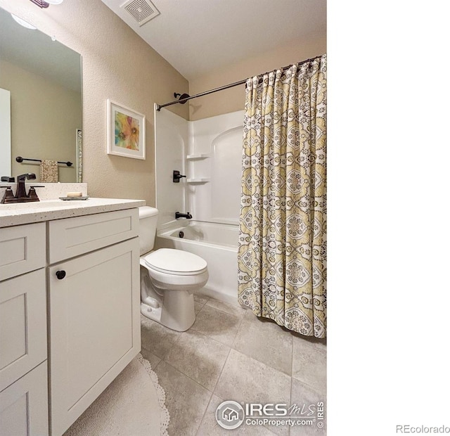 bathroom featuring vanity, toilet, shower / bath combo with shower curtain, and tile patterned flooring
