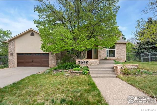 obstructed view of property featuring driveway, brick siding, and a garage