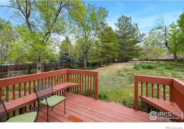 wooden deck with view of wooded area
