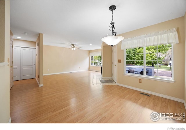 spare room featuring light wood-style flooring, baseboards, a ceiling fan, and recessed lighting