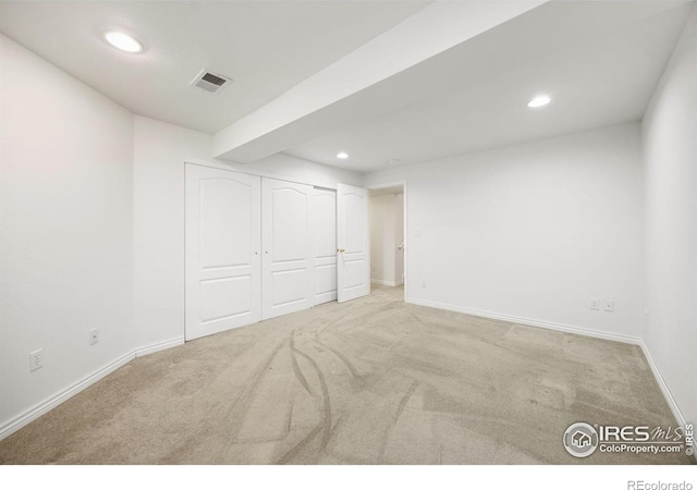 unfurnished bedroom featuring recessed lighting, carpet flooring, baseboards, and a closet