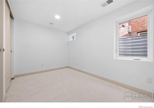 unfurnished bedroom featuring carpet, baseboards, recessed lighting, and a closet