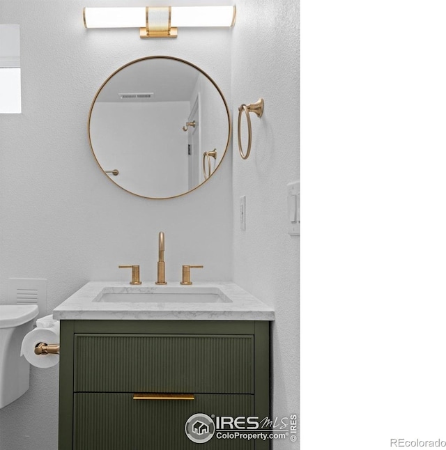 bathroom featuring toilet and vanity