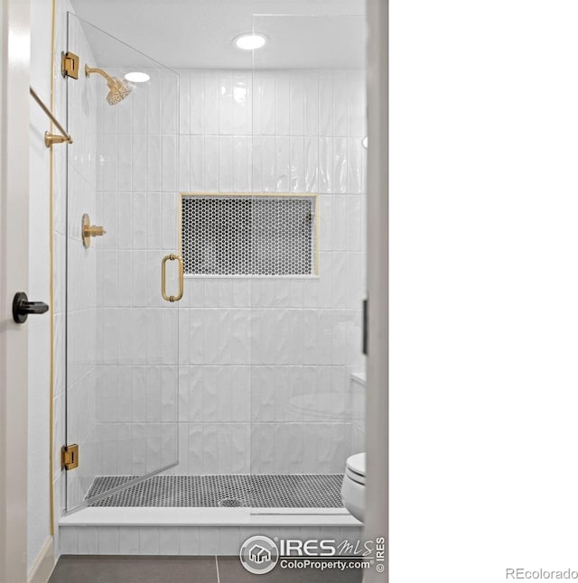full bath with toilet, a stall shower, and recessed lighting