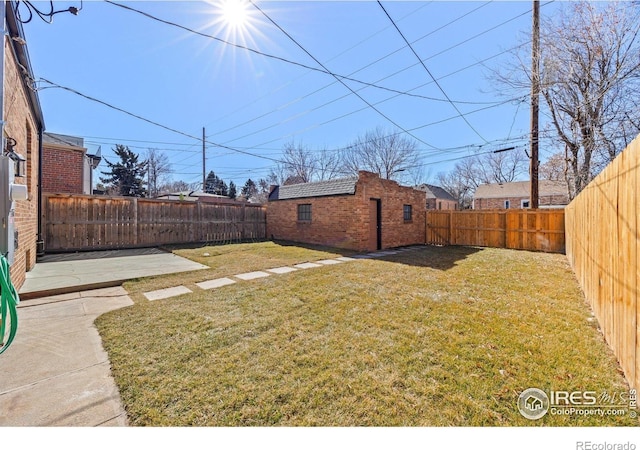 view of yard with an outdoor structure and a patio