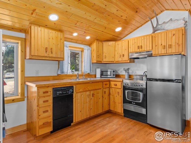 1221 Griffith Ct, Estes Park, CO 80517 - kitchen with appliances with stainless steel finishes, under cabinet range hood, vaulted ceiling, light wood-style flooring, and light brown cabinetry