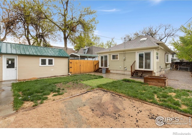 rear view of property featuring entry steps, a gate, and a patio area