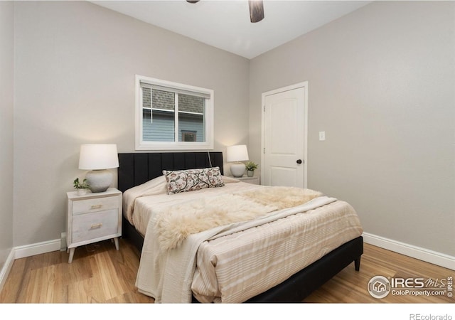 bedroom with baseboards, light wood finished floors, and a ceiling fan
