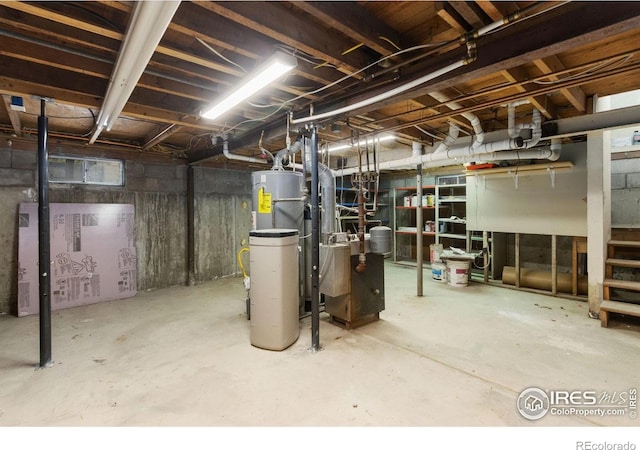 unfinished basement featuring water heater and electric water heater