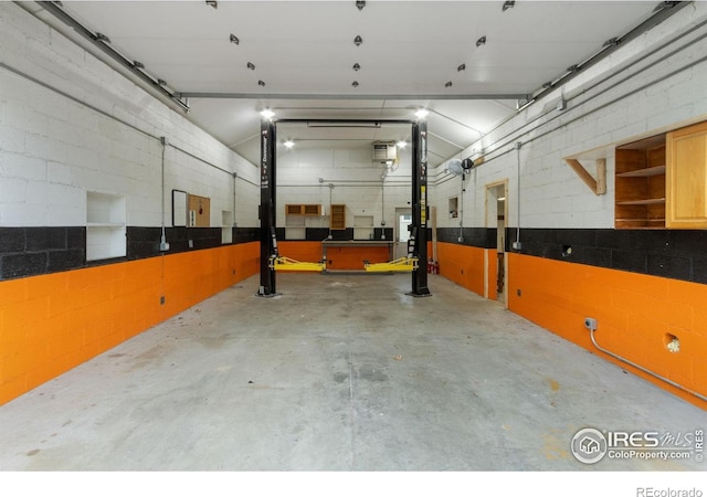 garage with concrete block wall
