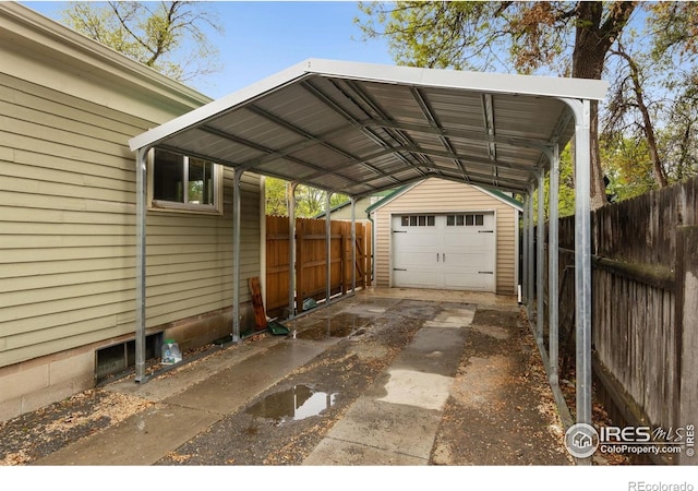 view of car parking with driveway, fence, and a carport