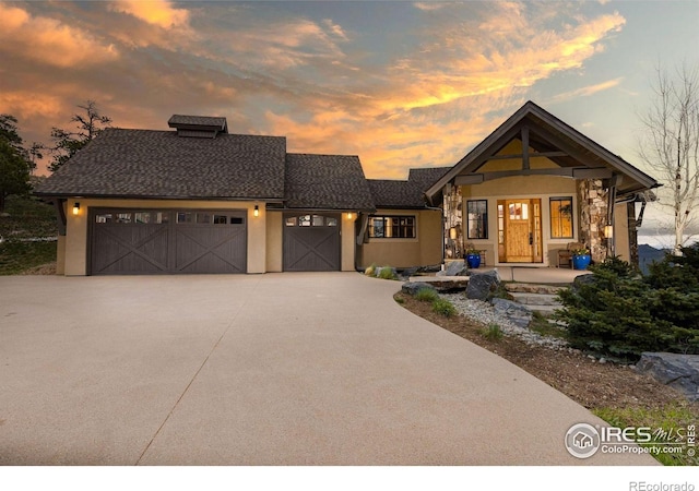 view of front of home featuring an attached garage, stucco siding, and driveway