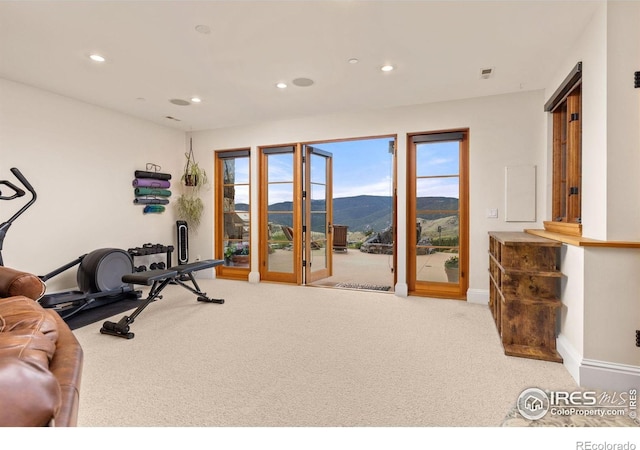 workout area with a mountain view, carpet, recessed lighting, and baseboards