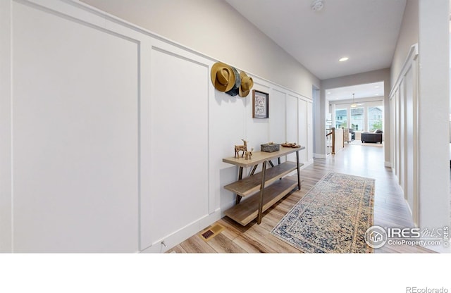 corridor with light wood-style flooring and recessed lighting