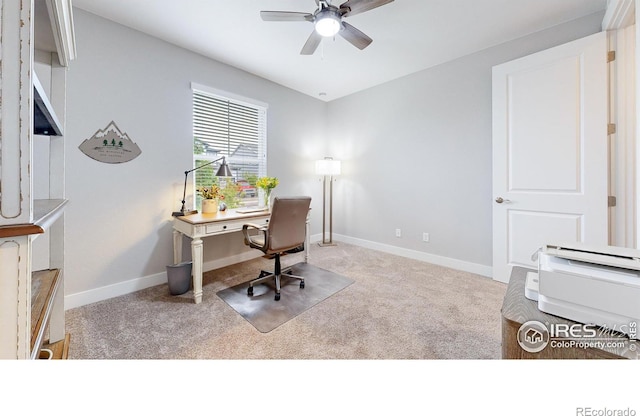 carpeted home office with a ceiling fan and baseboards