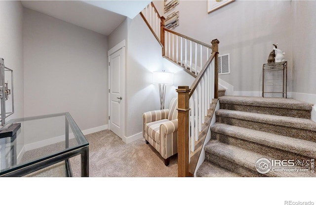 stairway with carpet flooring and baseboards