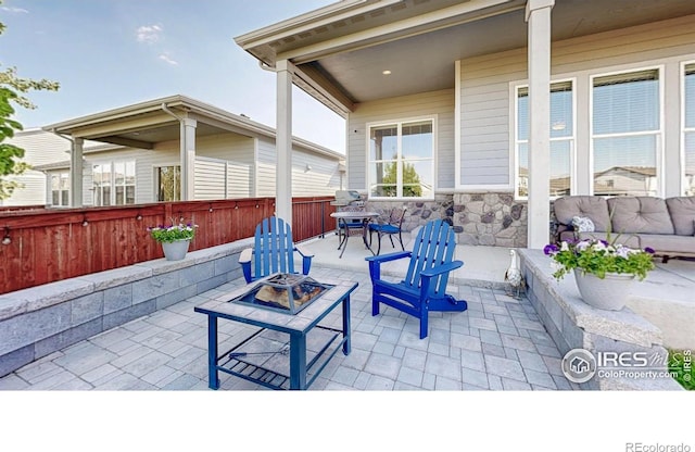 2137 Setting Sun Dr, Windsor, CO 80550 - view of patio / terrace with an outdoor fire pit and fence
