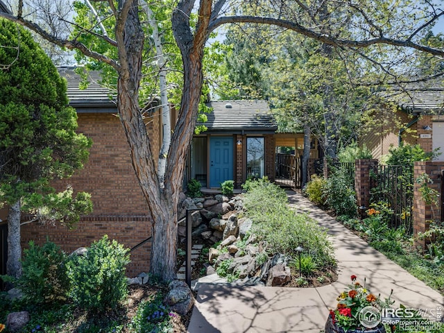 700 Poplar Ave, Boulder, CO 80304 - back of house with brick siding, fence, and a tile roof