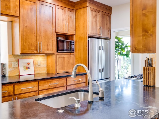 700 Poplar Ave, Boulder, CO 80304 - kitchen with freestanding refrigerator, a sink, black microwave, brown cabinets, and backsplash