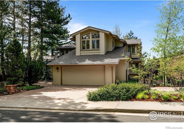560 Northstar Ct, Boulder, CO 80304 - view of front facade with an attached garage, roof with shingles, driveway, and fence