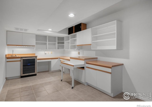 560 Northstar Ct, Boulder, CO 80304 - kitchen with open shelves, beverage cooler, a sink, white cabinetry, and recessed lighting