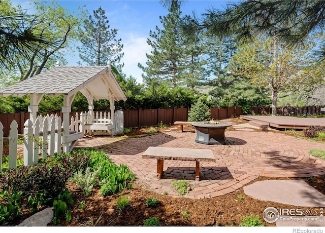 560 Northstar Ct, Boulder, CO 80304 - view of patio / terrace featuring an outdoor fire pit, a gazebo, and a fenced backyard