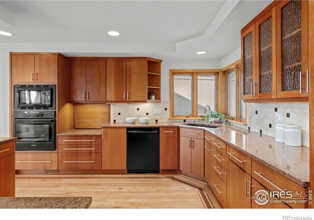 560 Northstar Ct, Boulder, CO 80304 - kitchen featuring black appliances, a sink, light wood-type flooring, light stone countertops, and decorative backsplash