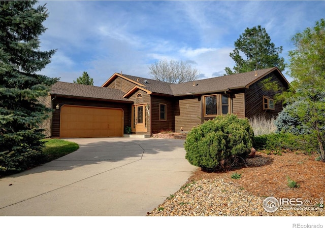 view of front of property with concrete driveway and a garage