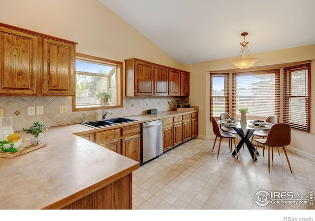 kitchen with dishwasher, a sink, light countertops, brown cabinetry, and decorative backsplash