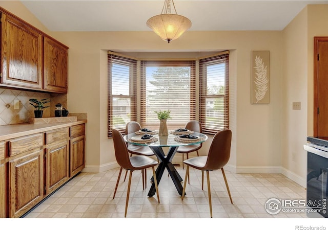 dining area featuring baseboards and light flooring