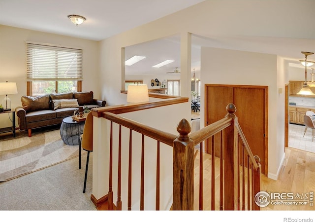stairway with wood finished floors and baseboards