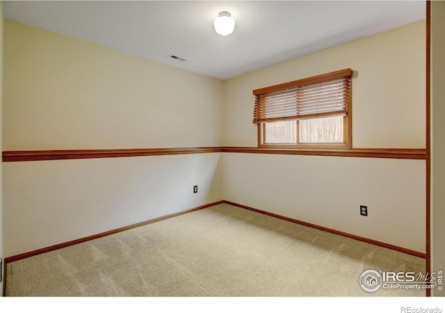unfurnished room featuring carpet floors and baseboards