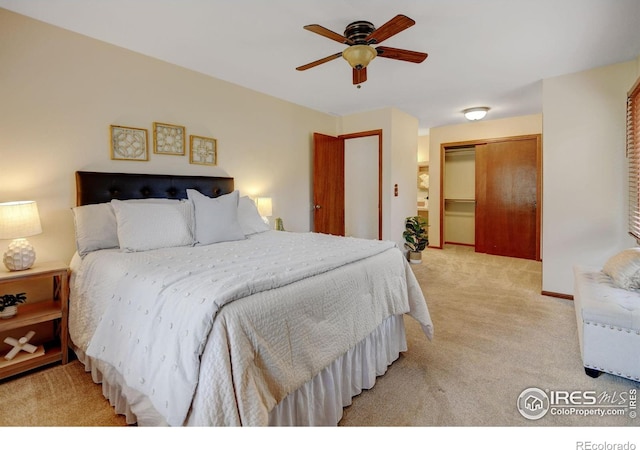 bedroom with light colored carpet, a closet, and a ceiling fan