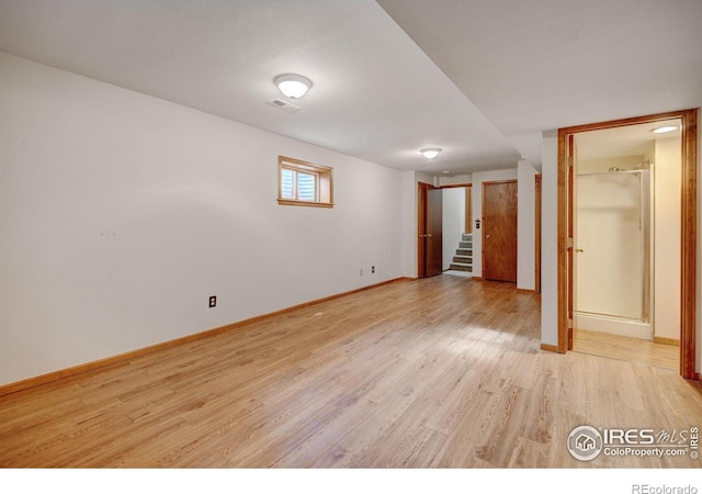 unfurnished bedroom featuring light wood-style floors and baseboards