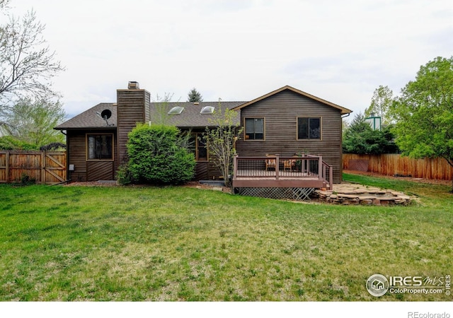 back of property featuring a wooden deck and a chimney